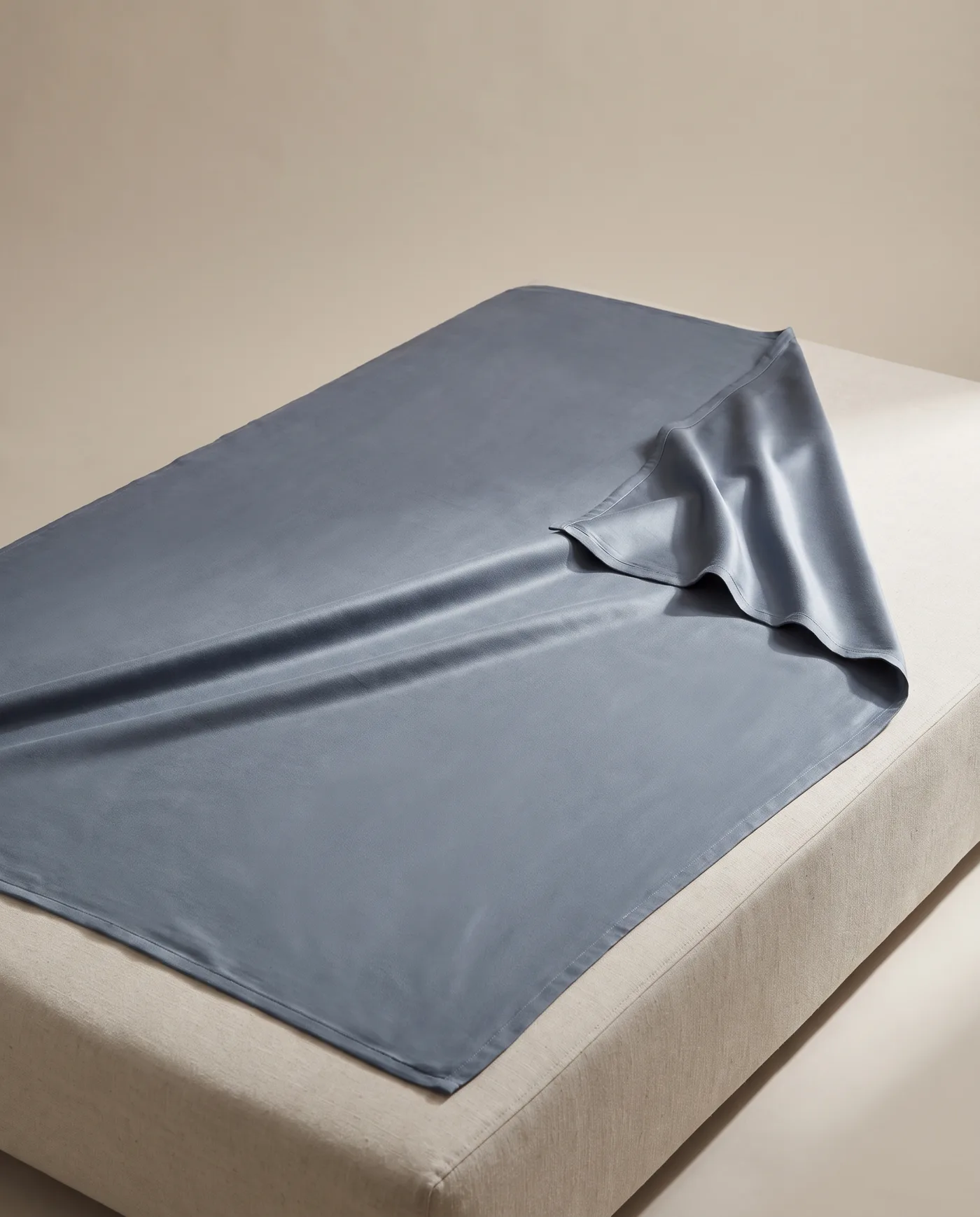 The slate bamboo blanket laid flat with one corner turned back.